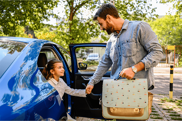 Father helping daughter out of car