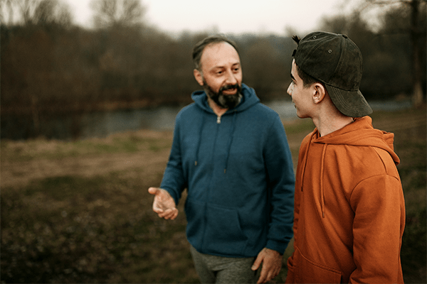 Father talking with teenage son