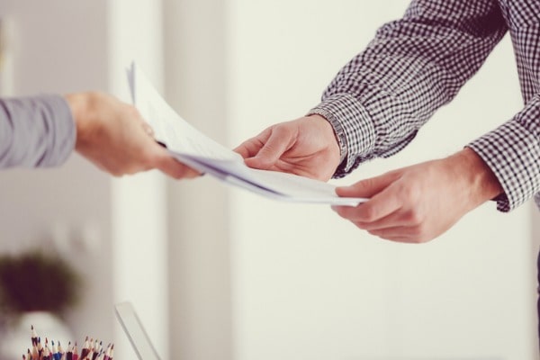 Lawyer handing documents to client