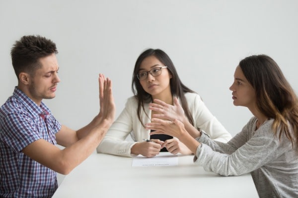 Couple fighting in front of a mediator