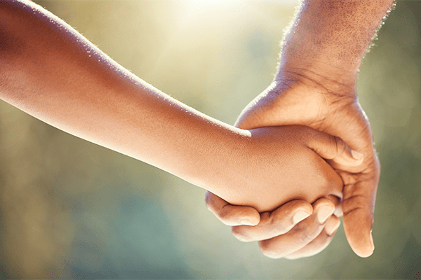 Child holding father's hand