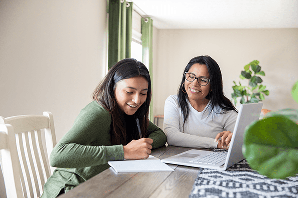 Mother helping daughter with homework