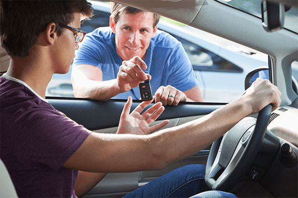 Father giving son car keys