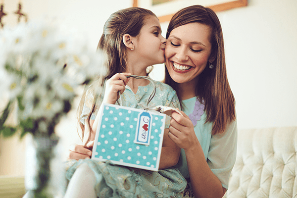 Daughter kissing mother on the cheek