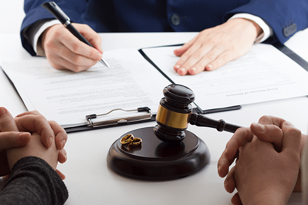 Lawyer and clients signing documents