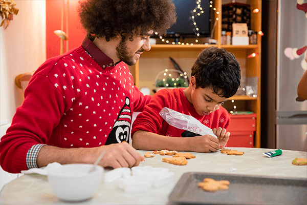 Father and son decorating cookies