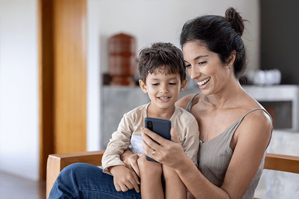 Mother and small son looking at cell phone