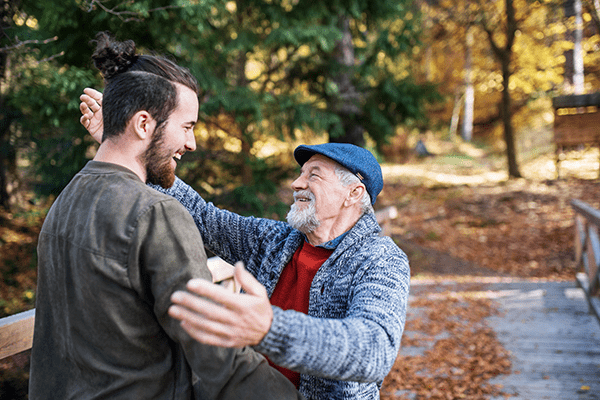 Older man hugging adult son