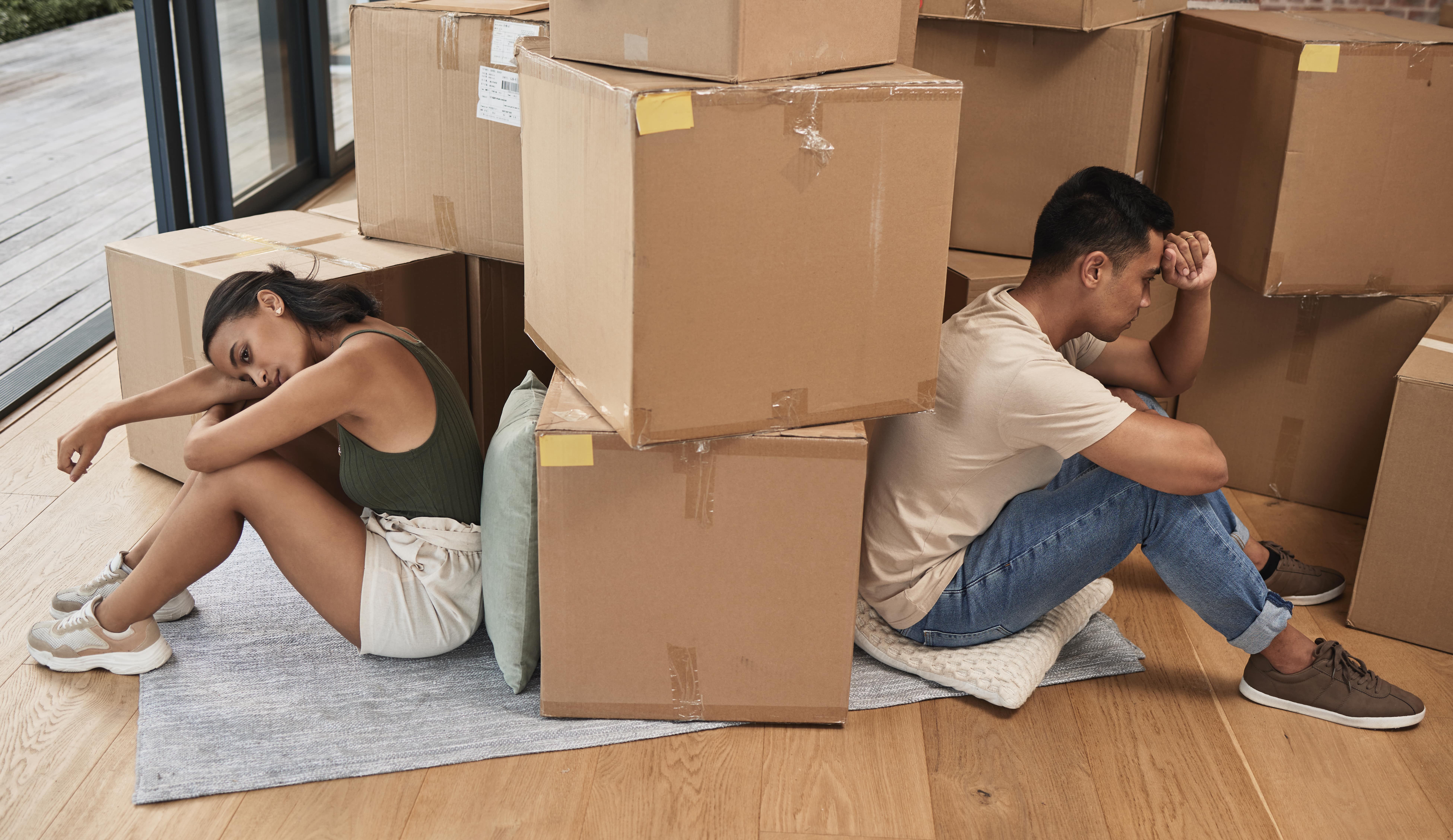 Couple packing moving boxes