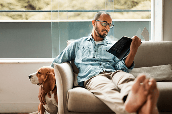 Father with dog watching iPad