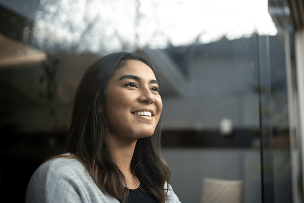 Woman smiling looking out a window