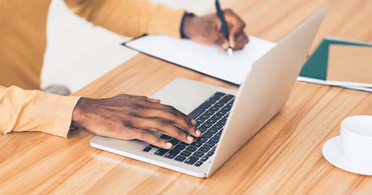 Man journaling on a computer