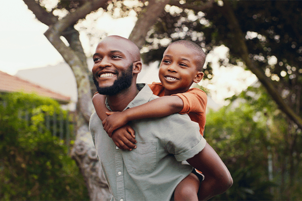 Father carrying son on his back