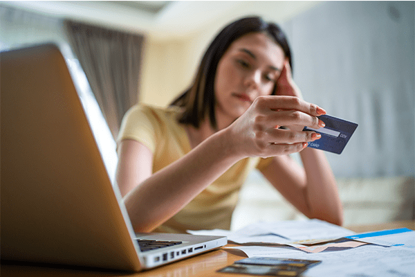 Woman looking at credit card