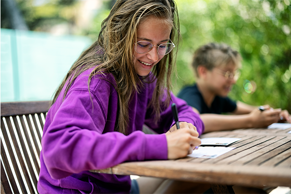 Teenager writing a letter