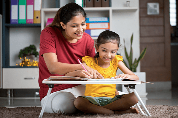 Mother helping daughter with worksheet