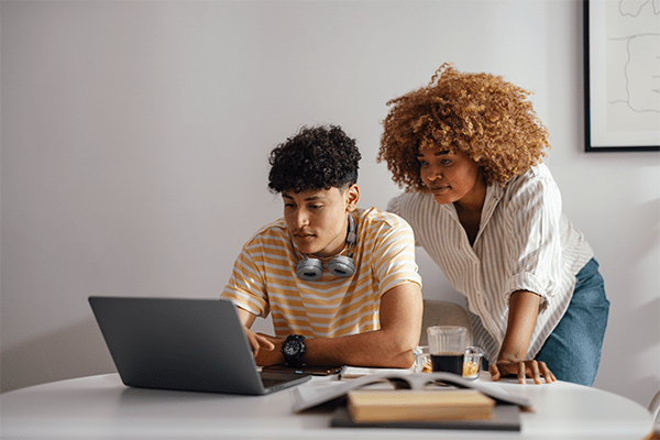 Mother helping teenage son with homework