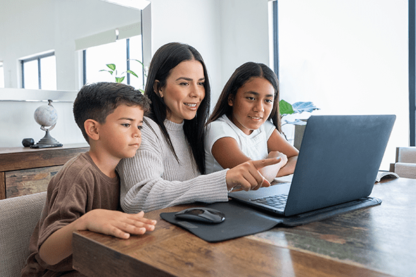 Mother and children looking at computer