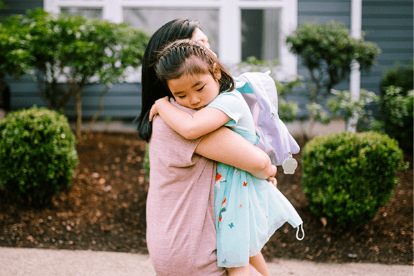 Mother hugging sad daughter